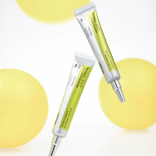 Two skincare serum tubes with yellow spheres on a light background