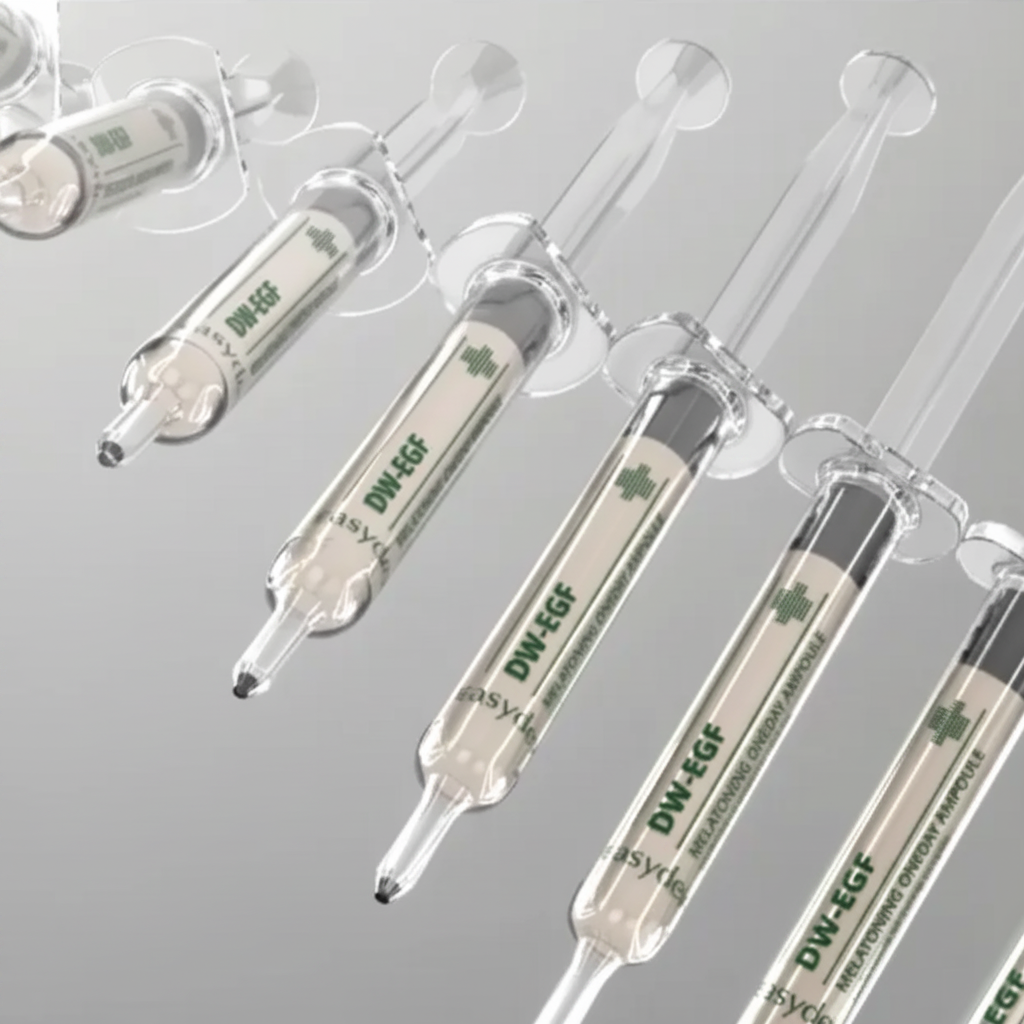 Multiple syringes with DW-EGF labels on a gray background