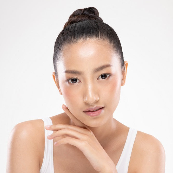 Woman with clear skin against a white background